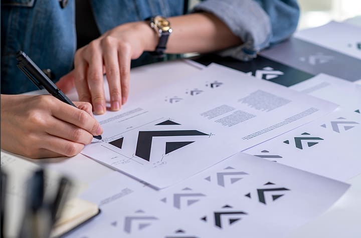 Image of woman designing a logo - Do you need a Logo, Brand or Identity?